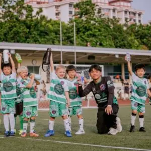 football coach guiding young players during training session in Singapore