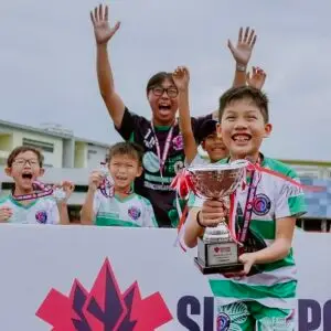 kids celebrating Singapore Youth League football league trophy win