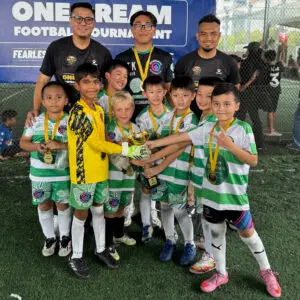 kids celebrating football tournament trophy win in Singapore